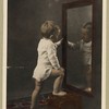 child looking into mirror