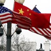A Secret Service agent guards his post on the roof of the White House as a lamp post is adorned with Chinese and US national flags in Washington, DC, on January 17, 2011.