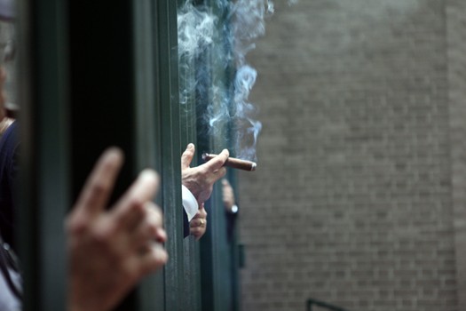 Cigar enthusiasts smoking at Paley Park on the 44th anniversary of the park, the same day smoking was banned in the city's public parks.