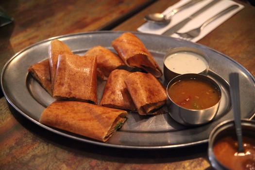 The giant thin crepe is made from rice and lentil flour and then stuffed with a savory filling. 
