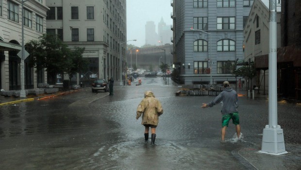 Nancy Zakhary and Eddie Lima of Brooklyn wade through flood waters filling the intersection of Main St and Plymouth St in Dumbo Brooklyn as Hurricane Irene reaches the New York City Area on August 28,