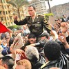 An Egyptian Army officer sympathizing with marchers is carried during an anti-government protest in Tahrir Square January 30, 2011 in Cairo, Egypt.
