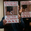 FDNY firefighters hold signs at Monday's City Council meeting