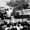 Iranian students climb over the wall of the U.S. embassy in Tehran during the Iranian Revolution, 4th November 1979. The students went on to seize the embassy staff, and hold 52 of them as hostages fo