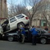 A jeep mounts a car in Midtown on March 4, 2011