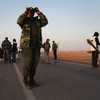 A rebel fighter scans the horizon for government troops on March 3, 2011 in Ajdabiya, Libya.
