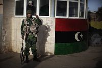 A Libyan opposition army soldier poses outside an army barrack in Benghazi on March 1, 2011.