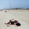Lying on the beach at Coney Island at the start of Memorial Day weekend.
