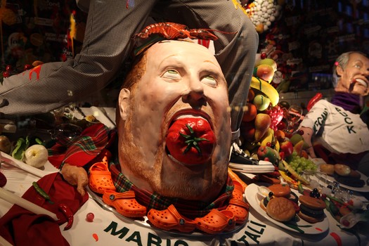 Chef Mario Batali depicted with a necklace of his signature orange Crocs.