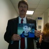 Michael Carey holds picture of his son Jonathan after testifying at state hearing on abuse at facilities for the disabled