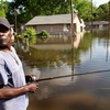William Jefferson fishes in the street near his flooded home in the King's Community neighborhood May 11, 2011 in Vicksburg, Mississippi. 
