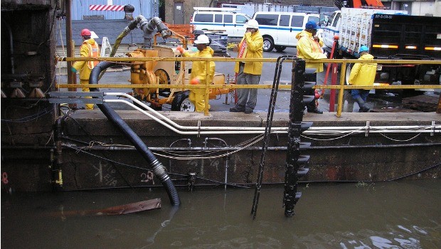 New York City Transit employees pumping water out of the 148th Street / Lenox Subway Yard.