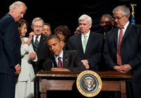 US President Barack Obama signs the Dodd-Frank Wall Street Reform and Consumer Protection Act alongside members of Congress, the administration and US Vice President Joe Biden