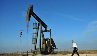 Barack Obama walks past an oil rig to a stage to speaks at an oil and gas production fields on federal lands March 21, 2012 near Maljamar, NM.