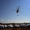 A Louisiana National Guard helicopter carries away sandbags as it takes part in an operation to fortify offshore barrier islands from incoming oil June 1, 2010