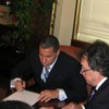 Gov. David Paterson begins signing the 6,900 line item vetoes.