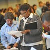 Job seekers look for employment at a job fair in Los Angeles on September 20, 2010