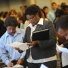 Job seekers look for employment at a job fair in Los Angeles on September 20, 2010
