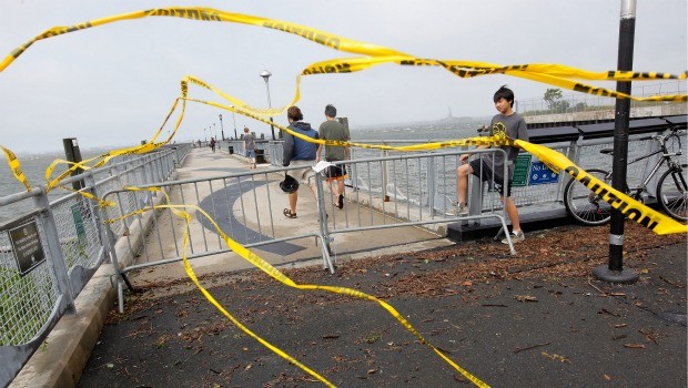 Residents slip past a barricade to enter Valentino Pier in Red Hook Brooklyn as the skies clear in the aftermath of Hurricane Irene on August 28, 2011 in New York City. 