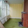 room with fireplace and green carpet