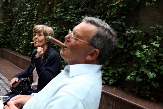 Sally Sorkin, 65, and her husband Trevor Sorkin, 69, from England, smoking in Paley Park.