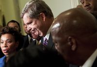 Secretary of Agriculture Tom Vilsack listens as members of the Congressional Black Caucus speak to the press after a meeting on Capitol Hill to discus the forced resignation of Shirley Sherrod.