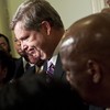 Secretary of Agriculture Tom Vilsack listens as members of the Congressional Black Caucus speak to the press after a meeting on Capitol Hill to discus the forced resignation of Shirley Sherrod.
