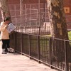 A woman reads the paper near the Grant housing project
