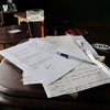 Songwriting, pieces of paper, writing, pen.