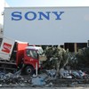 A damaged coca cola van sits in front of a Sony warehouse building in Sendai, Japan on March 19, 2011 eight days after the devastating earthquake and tsunami.