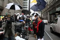 French reporter doing a live broadcast in front of Dominique Strauss-Khan's rented apartment.