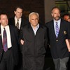 IMF head Dominique Strauss-Kahn (C) is taken out of a police station in New York on May 15, 2011.