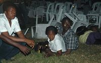 Survivors are seen at an Ethiopian-owned restaurant in the Kabalagala area of Kampala late on Sunday,  moments after twin bomb blasts tore through crowds of football fans watching the World Cup final