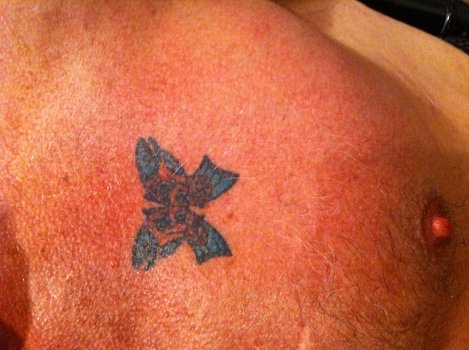 This tattoo has the appearance of a butterfly from a few feet away 