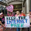 Protesters hold a rally to support 'net neutrality' and urge the FCC to reject a proposal that would allow Internet service providers to provide paid fast lanes for websites.