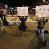 Demonstrators sit on a street during a protest of Tuesday's fatal police shooting of Keith Lamont Scott in Charlotte, N.C. on Wednesday, Sept. 21, 2016. 