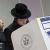 Voters mark their ballots, Tuesday, Nov. 8, 2016, in the Boro Park neighborhood in the Brooklyn borough of New York. The neighborhood has a diverse population, including many orthodox Jews. 