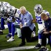 The Dallas Cowboys, led by owner Jerry Jones, center, take a knee prior to the national anthem before an NFL football game against the Arizona Cardinals. Sept, 25 2017. 