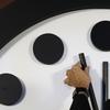 Robert Rosner, chairman of the Bulletin of the Atomic Scientists, moves the minute hand of the Doomsday Clock to two minutes to midnight during a news conference at the National Press Club in Washingt