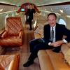 Ken Curry, president of Petersen Aviation, sits on a long, plush sofa aboard one of his company's corporate jets, a $5,000-an-hour Gulfstream 4. Dec 4, 1997.