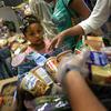 Low-income residents select free bread and produce at the Community Food Bank of New Jersey on August 28, 2015, in Egg Harbor, New Jersey. 