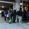 Crowds lined up outside of the New York City Rescue Mission on Christmas Day for the annual coat drive and free food.