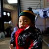 Raymond Yu, 1 year old, whose mother owns a dry cleaners in the Rockaways where heat and electricity have yet to be restored.