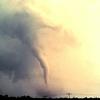 A tornado forming above powerlines