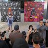 A crowd gathers to view Banksy's latest work on October 18, 2013 in New York City