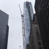 A stuck crane dangles over W. 57th Street near Carnegie Hall