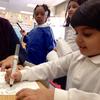 A pre-K students writes a sentence at Mount Vernon Elementary School in Newark. 