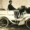 Giacomo Puccini driving a car.