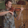 Rob Landes tests several different violins.