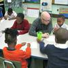 Teacher Chad Hamilton helps his students write declarative statements.